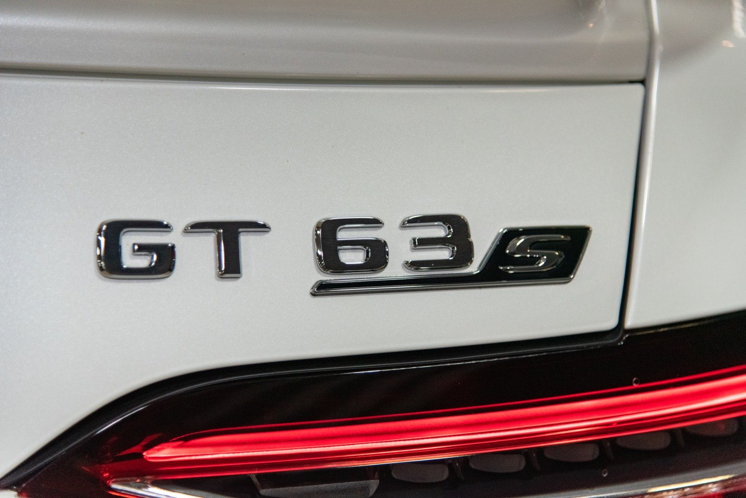 Close-up of AMG GT 63 S badge and red rear tail light