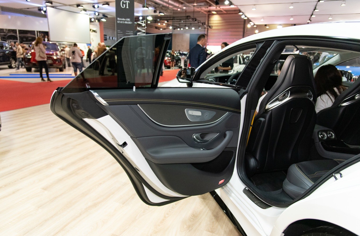 Luxury car rear door panel with premium trim and controls