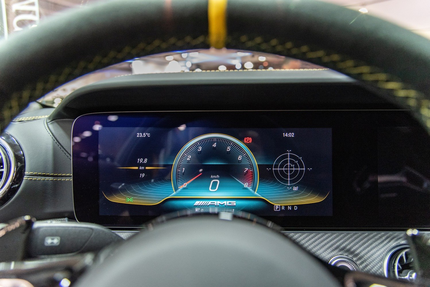 Digital speedometer and telemetry display of a luxury coupe dashboard.