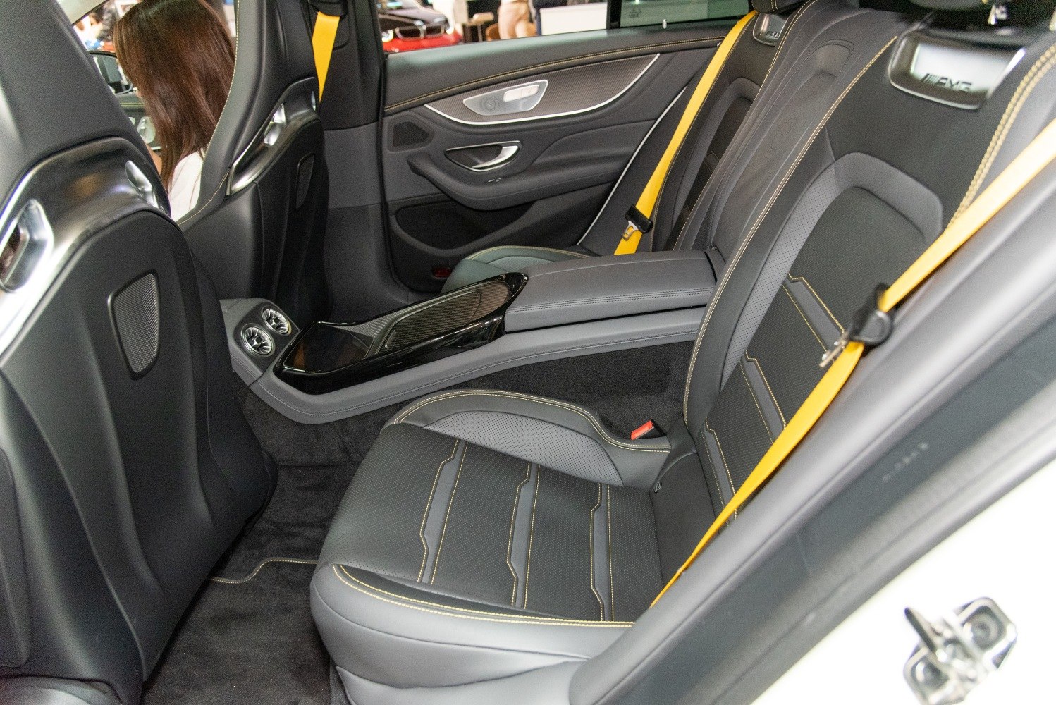 Luxury rear seats with carbon fiber trim and yellow accents