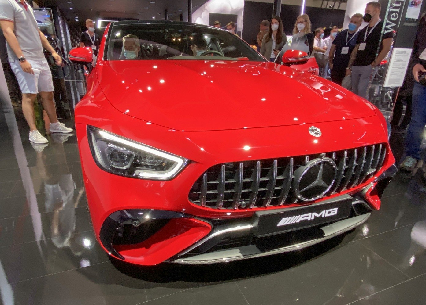 Close-up of red luxury sport sedan with AMG grille and LED headlights