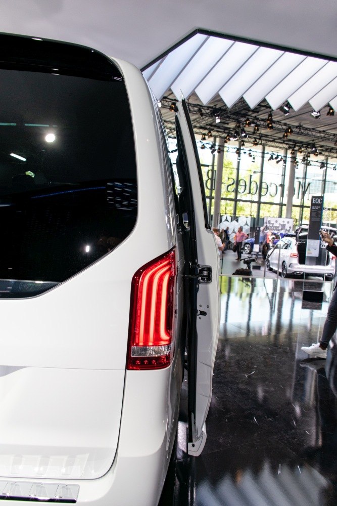 Rear view with LED taillight and open rear side door.