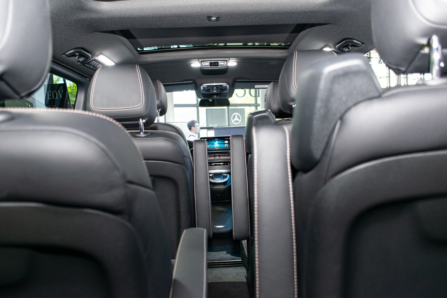 Interior view of leather seats with panoramic roof and digital dashboard