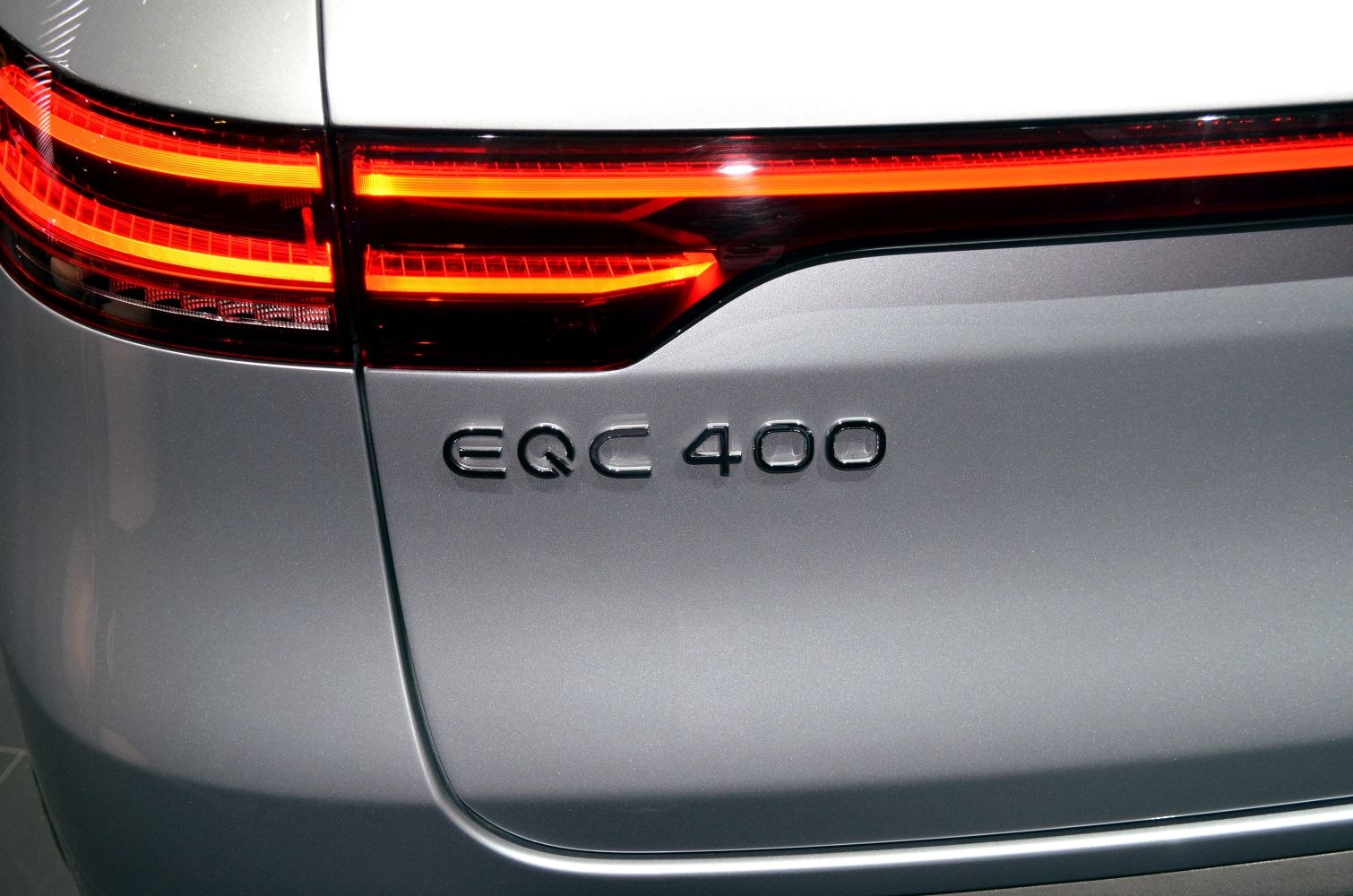 Rear LED taillight and EQC 400 badge on silver vehicle body