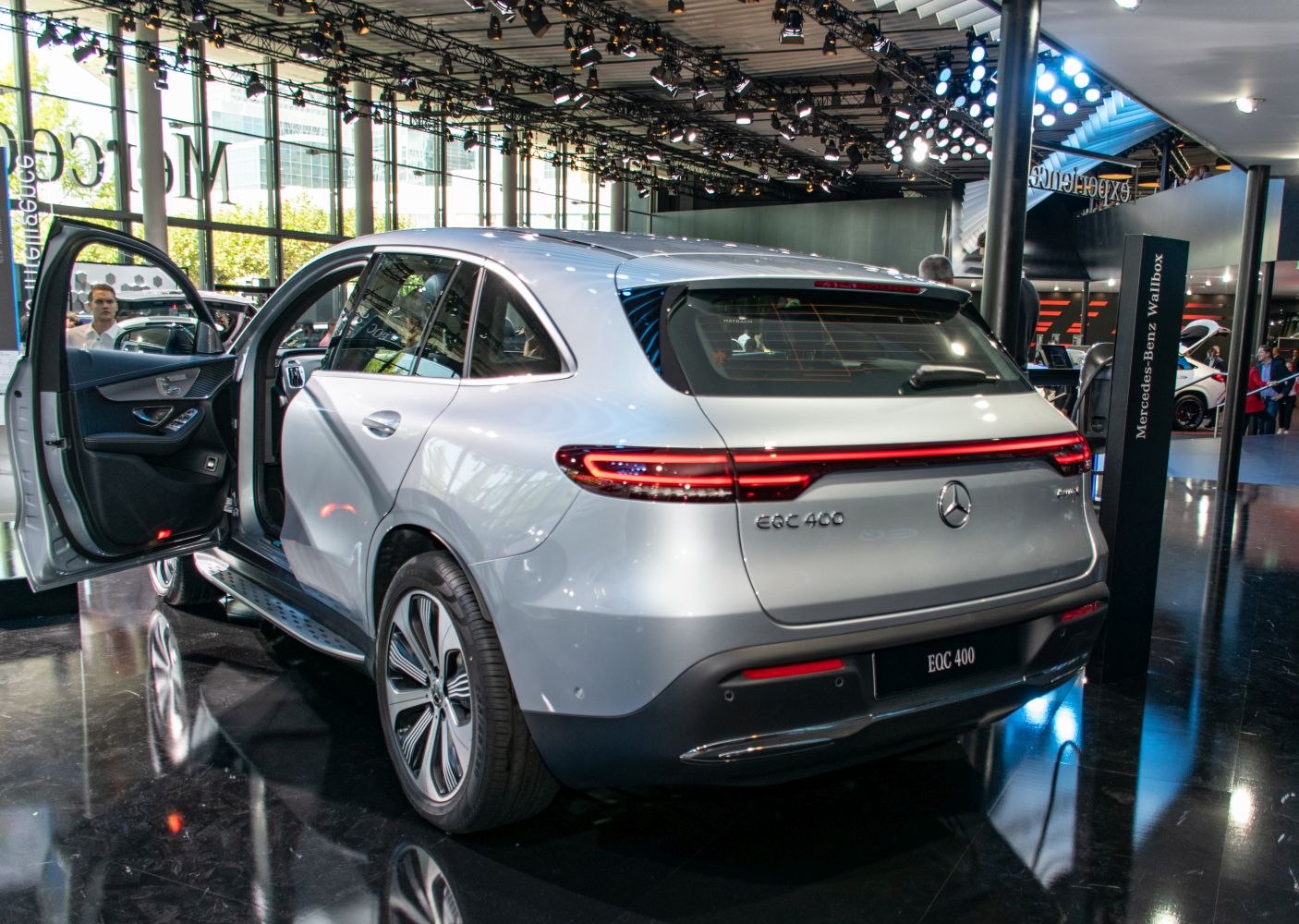 Rear and side view of electric SUV with open driver door and LED taillights