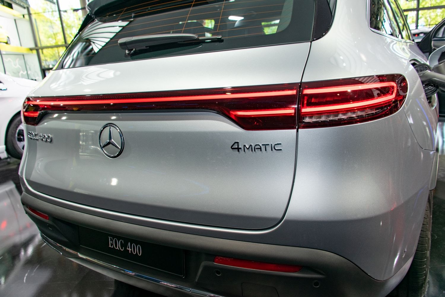 Rear LED tail lights and 4MATIC badge on silver electric SUV