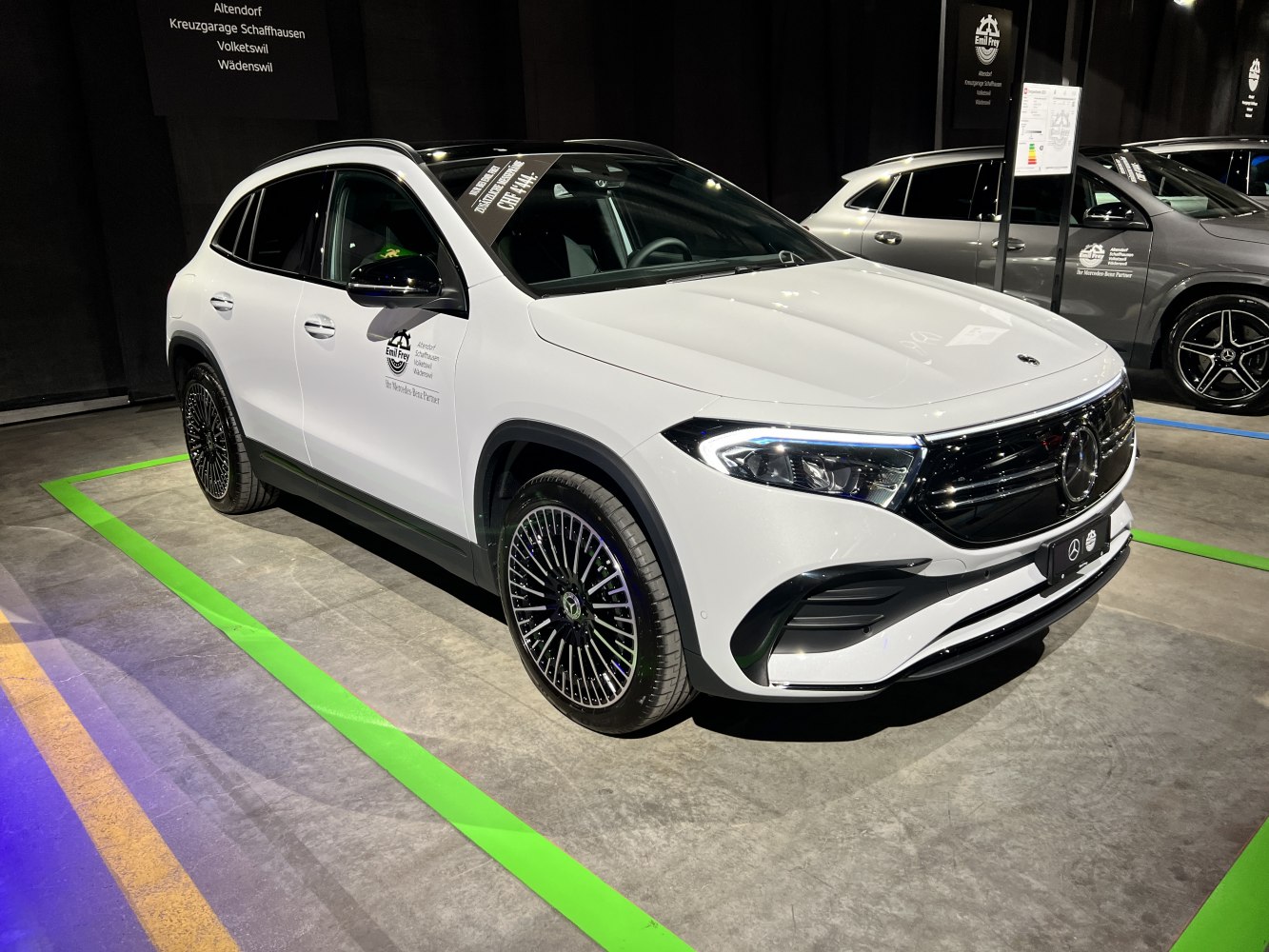 White electric SUV front side with LED headlights and alloy wheels
