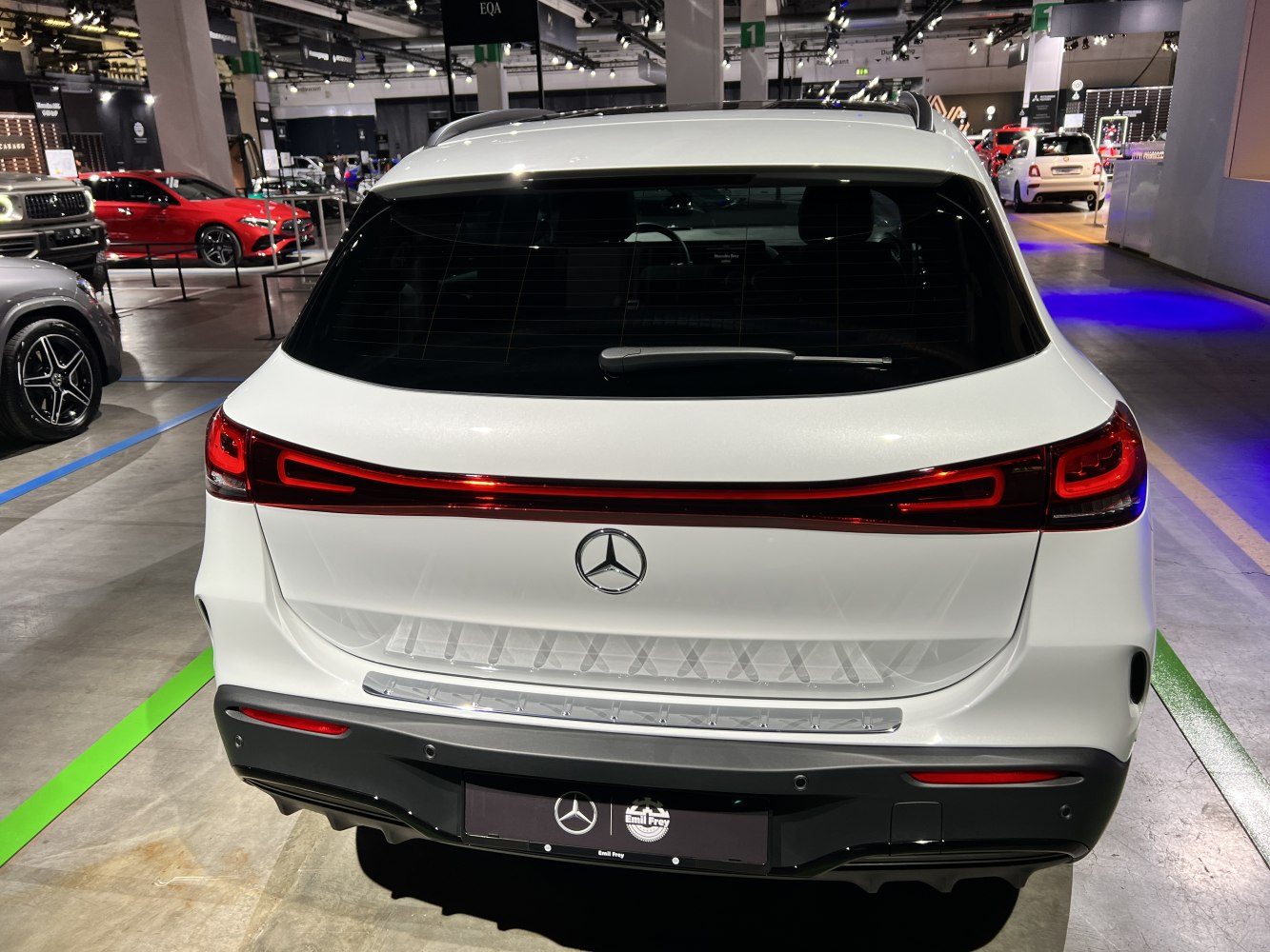 Rear view with full LED horizontal tail light strip and rear window wiper.