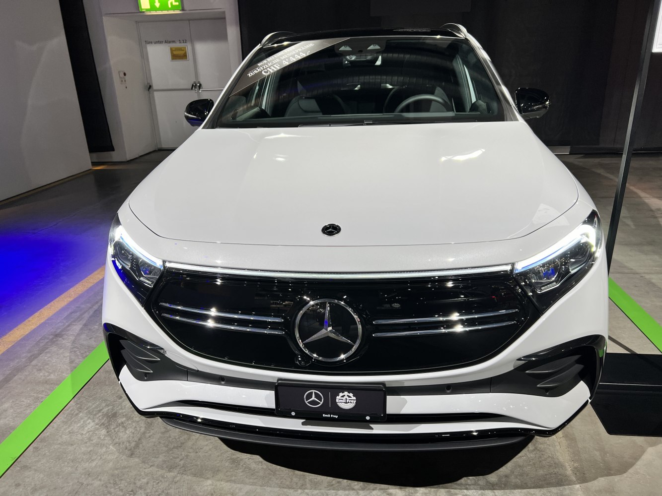 LED headlights and glossy black grille on white front SUV