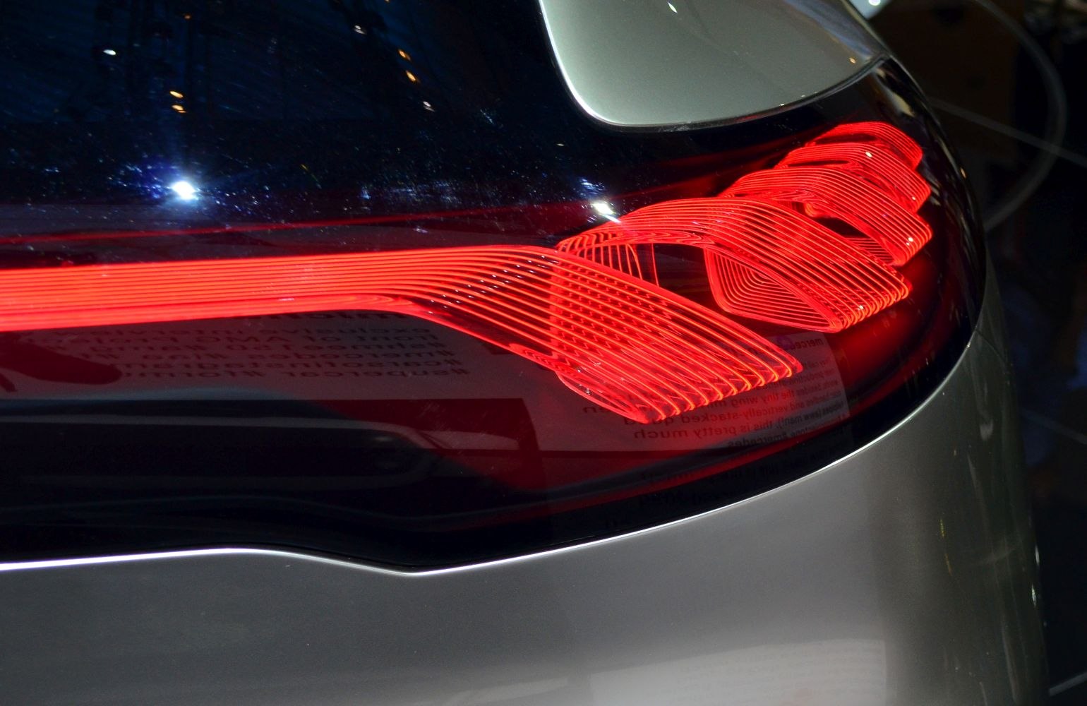 Glowing red LED tail light with intricate line design