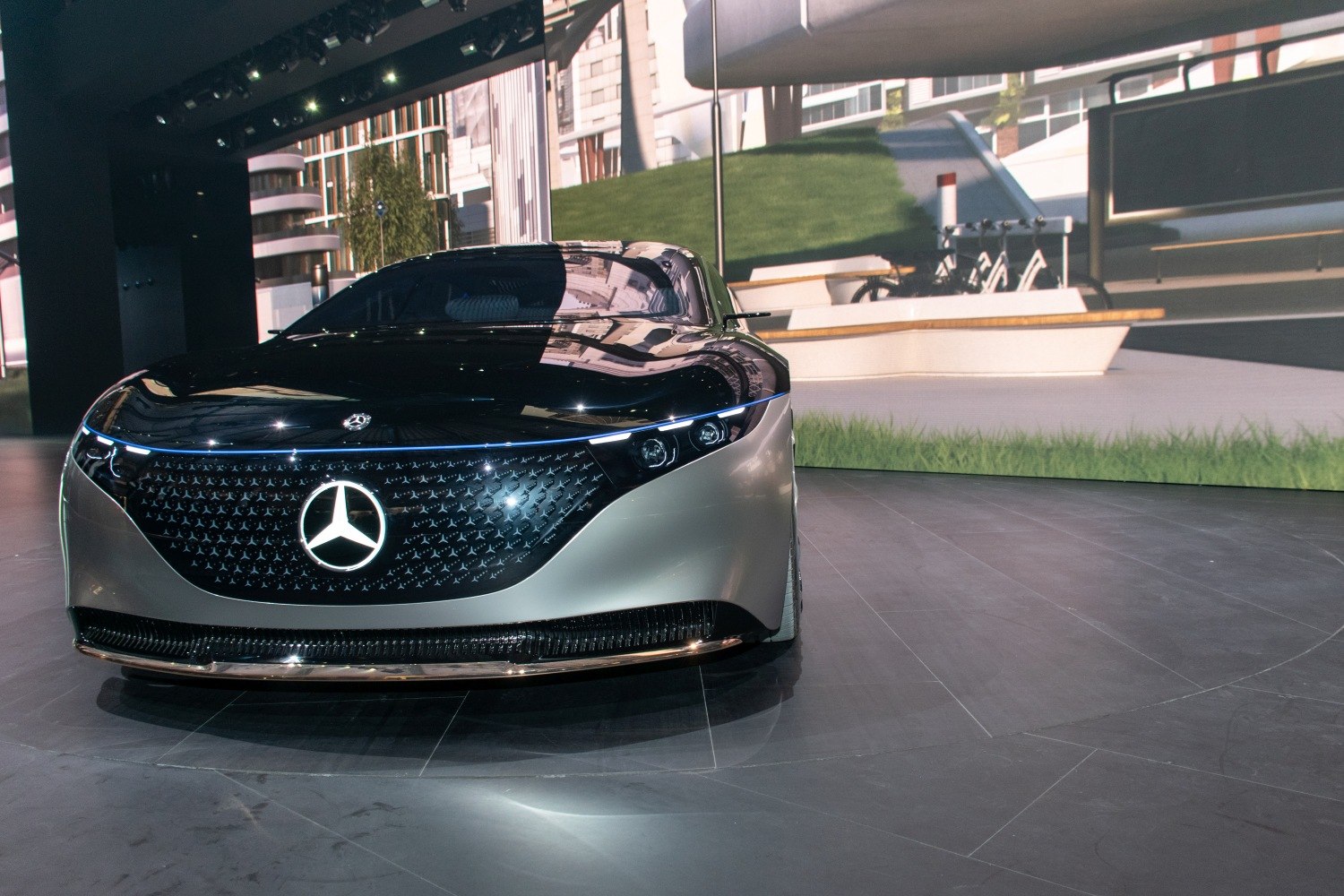 Futuristic front grille with illuminated Mercedes star and sleek LED headlights.