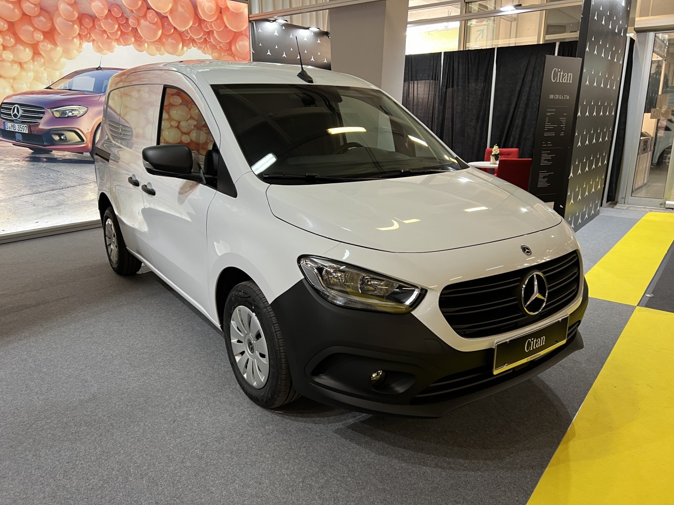 White panel van front with sleek headlights and black grille