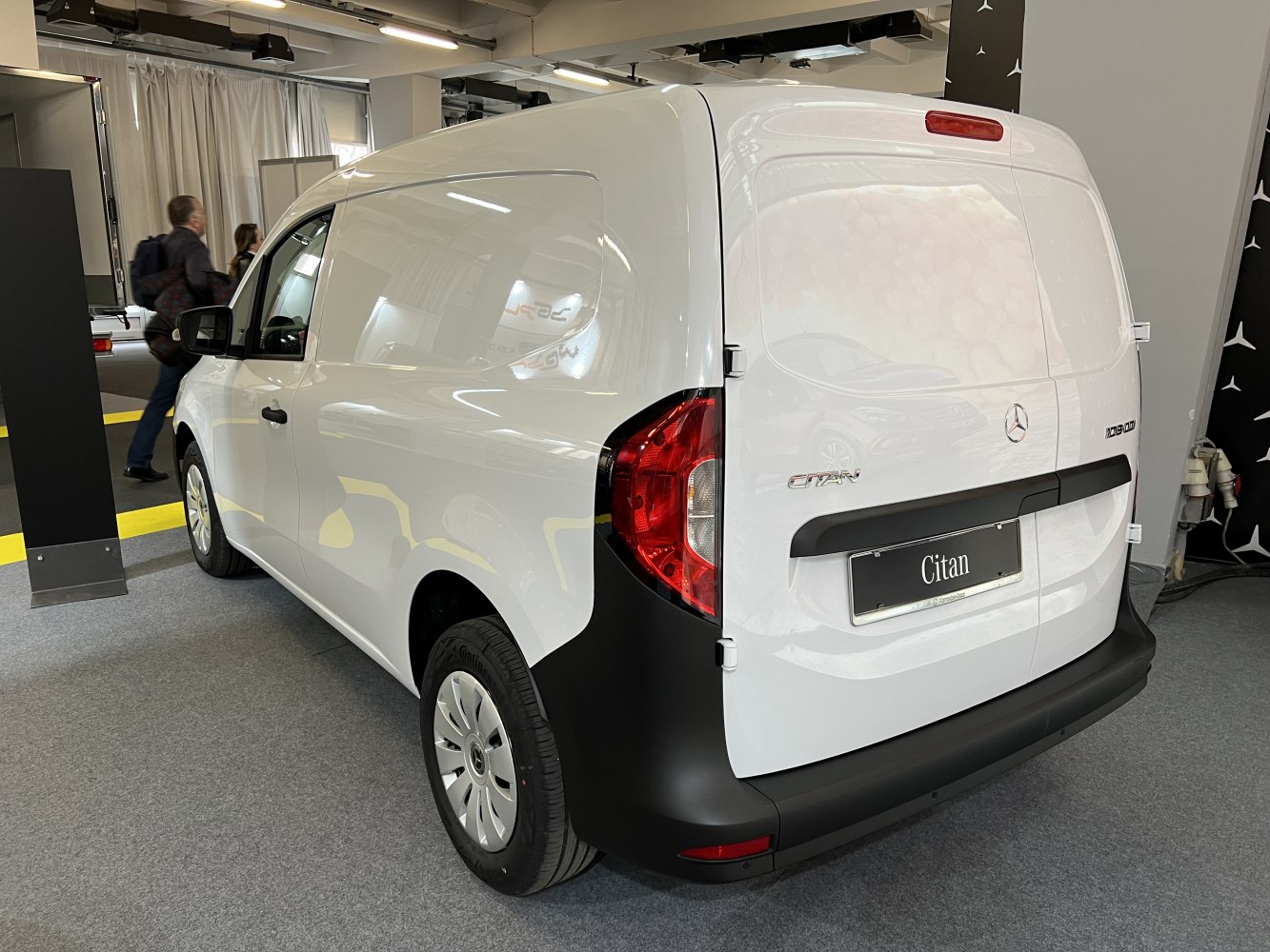 Rear and side view of white panel van with modern tail lights and dual rear doors