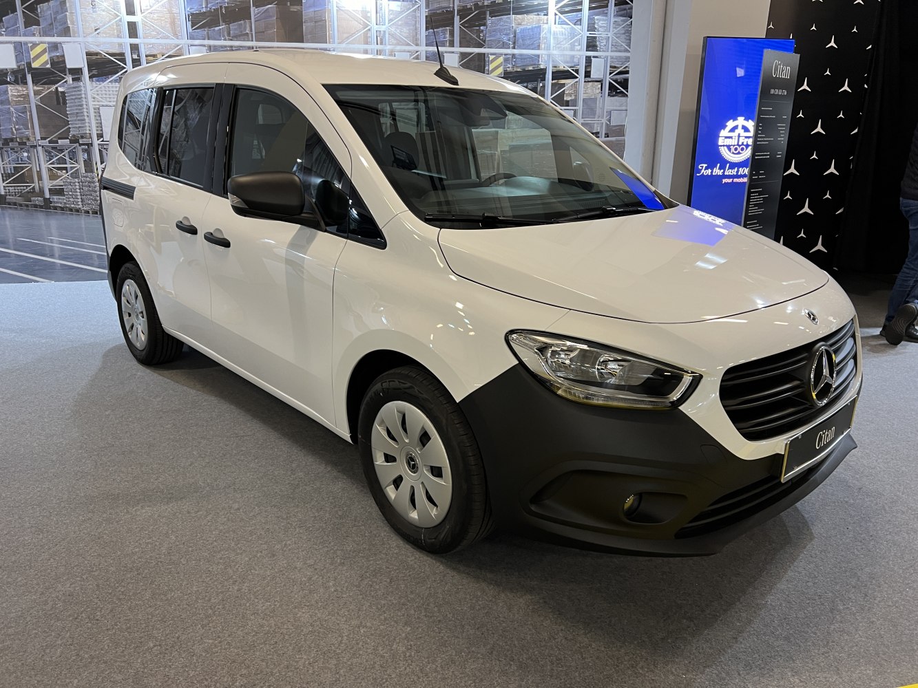 White compact van front-side view with black grille and headlights