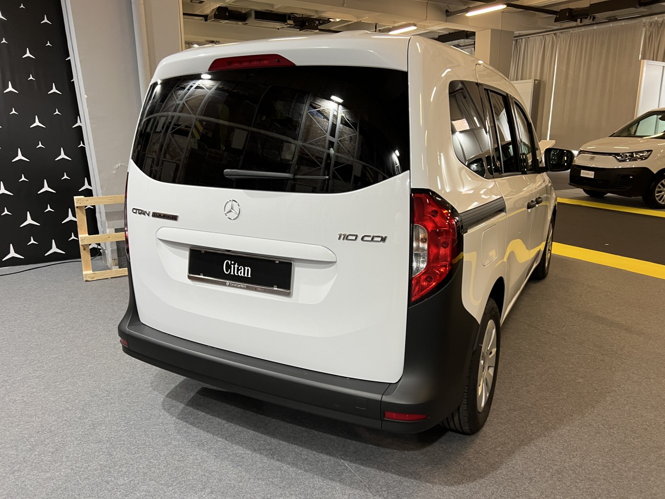 Rear view of a compact van with tinted window and black bumper