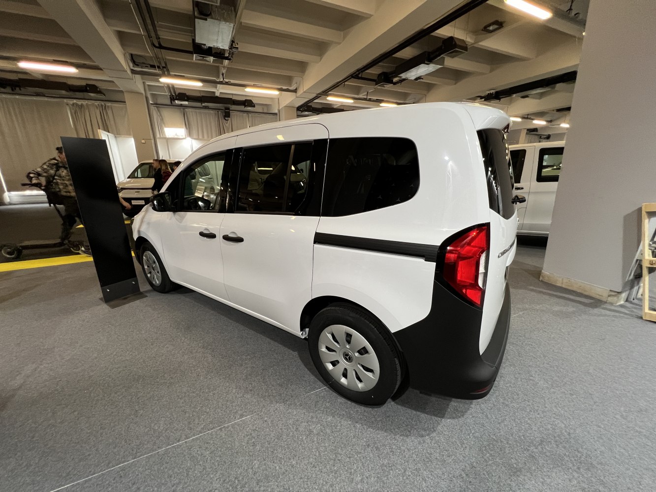 Side rear view of compact multi-purpose vehicle with sliding door and large rear window