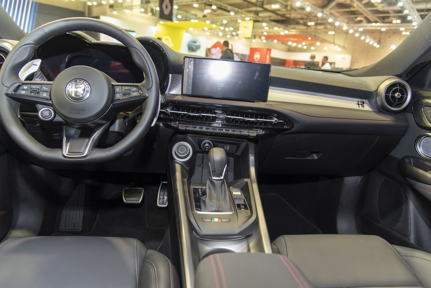 Steering wheel with brand badge and sleek dashboard with digital display