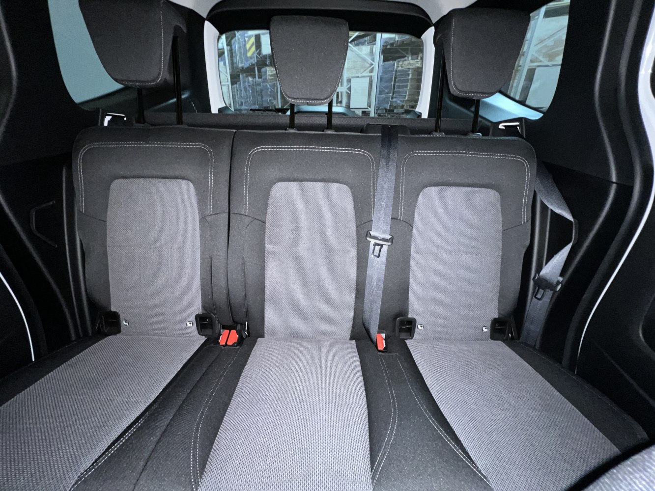 Rear fabric seats with headrests and seatbelt in vehicle interior
