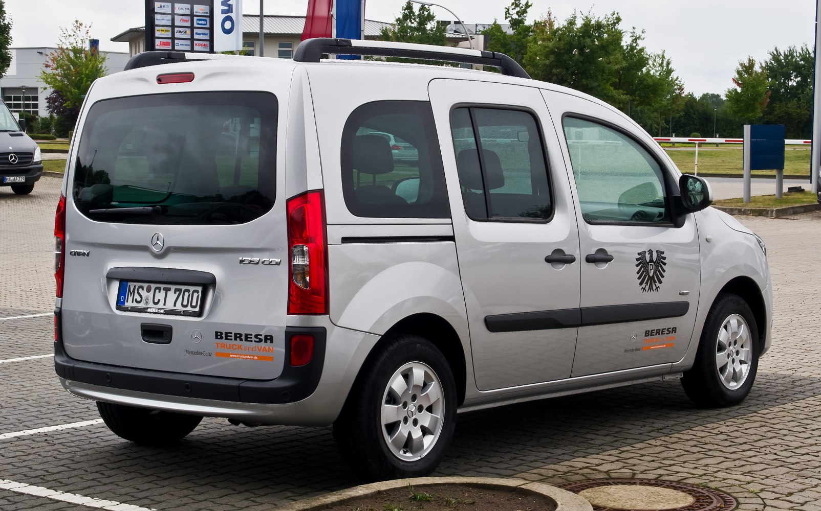 Rear view of long van with sliding door and roof rails