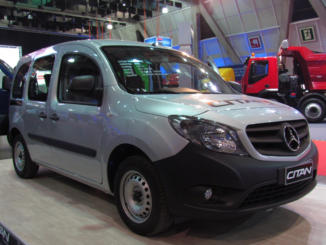 Front-side view of extended passenger van with black grille and headlights