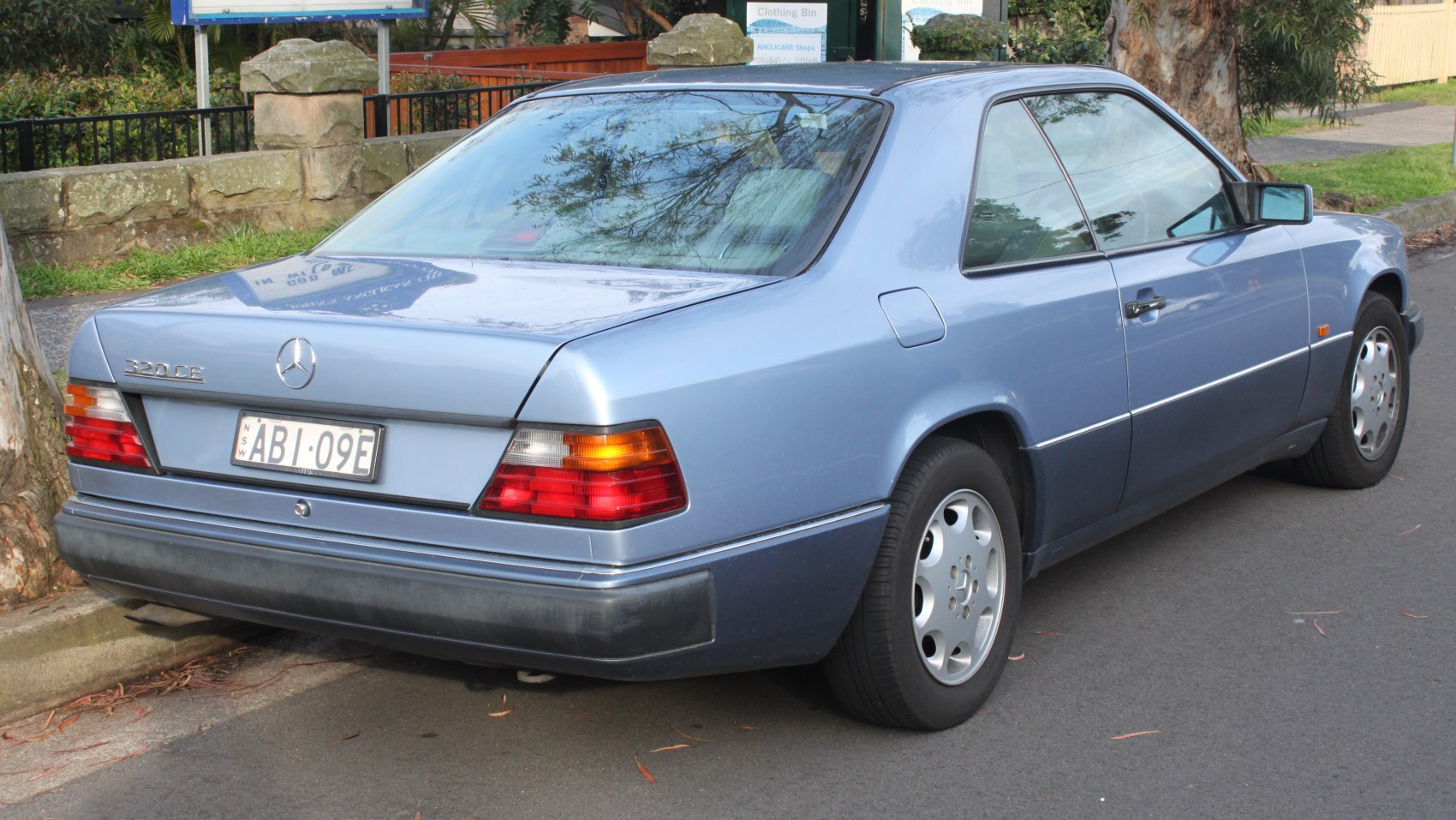 Rear view of a classic coupe with taillights and alloy wheels