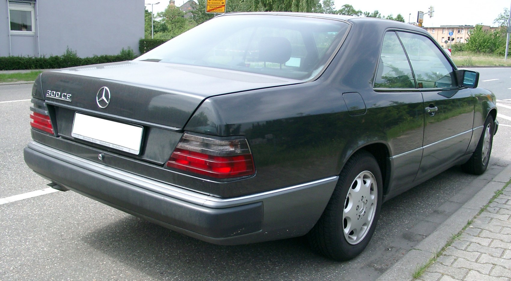 Rear and side view of a classic coupe with distinct tail lights and smooth body lines