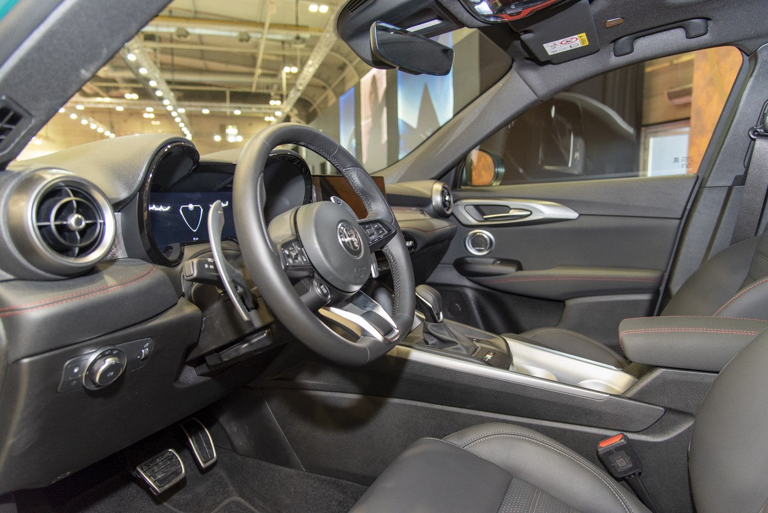 Sporty steering wheel with digital instrument cluster and modern dashboard design