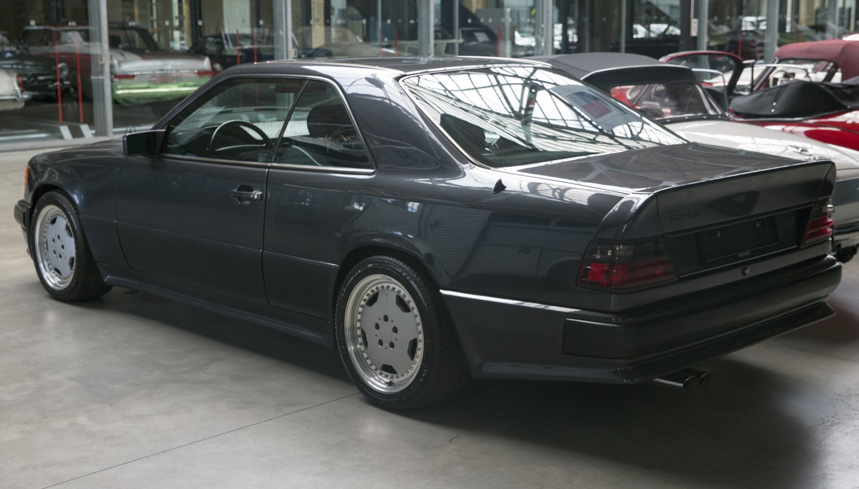 Black AMG coupe rear profile with distinctive wheels and spoiler
