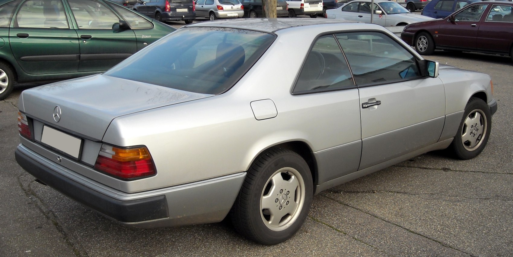 Rear side view of silver luxury coupe with iconic taillights and two-door design