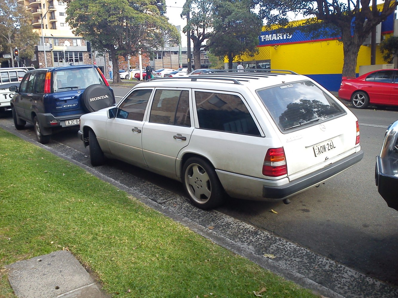 Rear side view of a classic estate car with rear lights and roof rails.