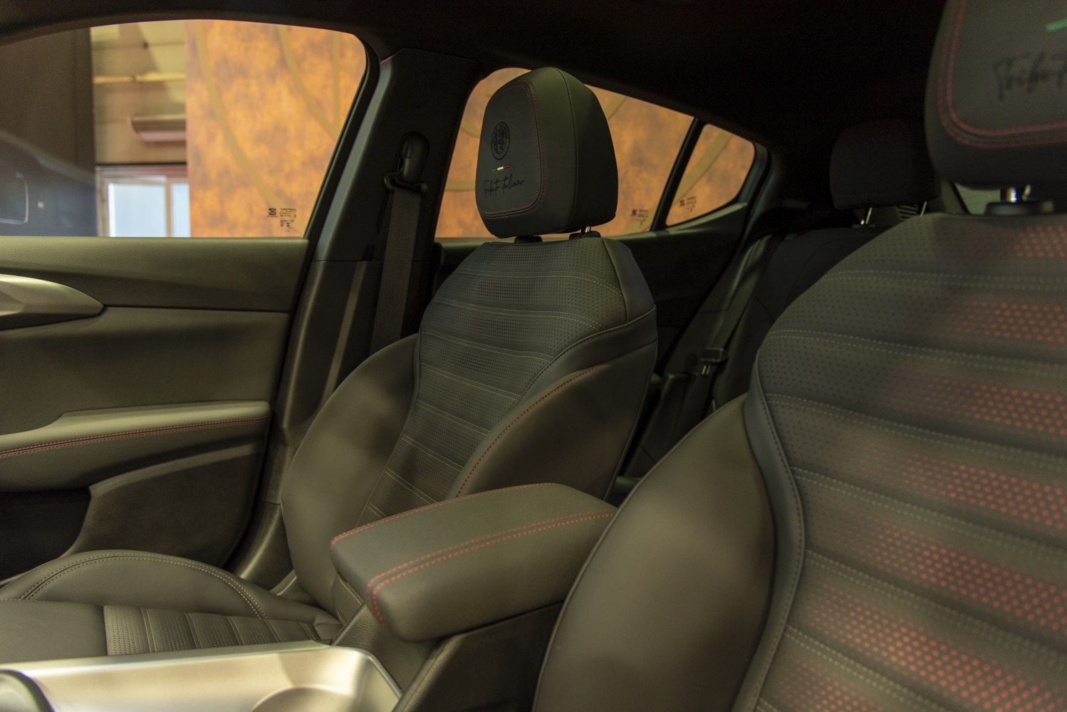 Premium leather sports seats with detailed stitching and branded headrests