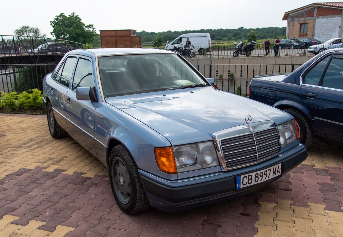 Front and side view of a classic sedan with angular headlights and prominent grille