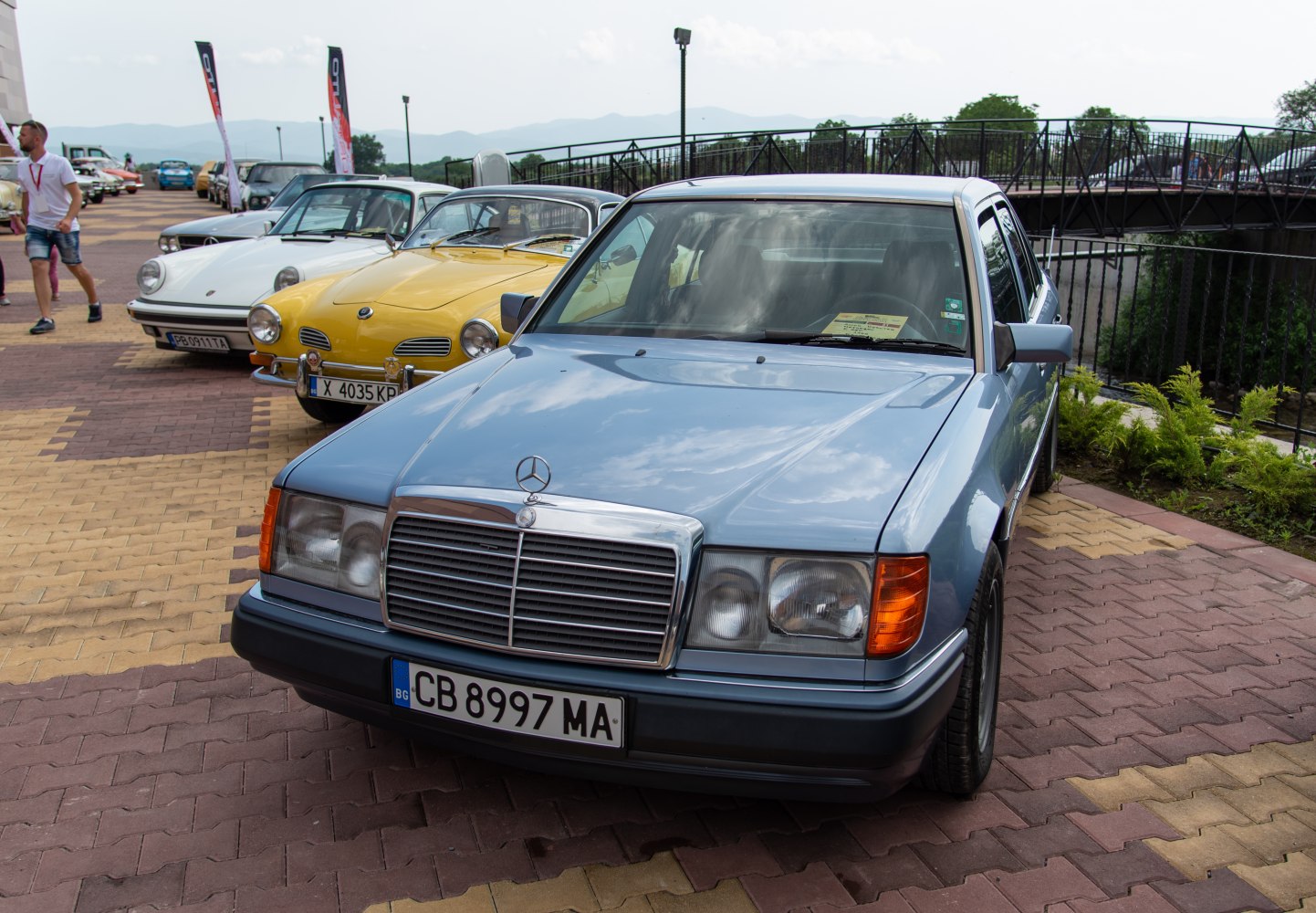 Sharp square headlights and large chrome grille on a classic sedan front.
