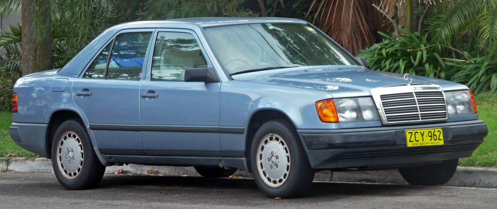 1980s sedan with square headlights and chrome grille, four-door compact design.