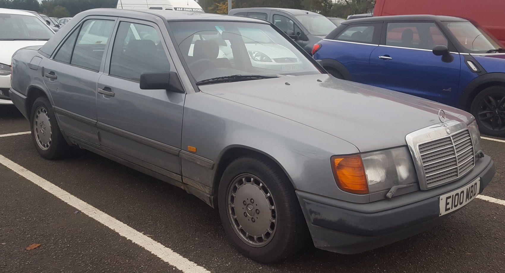 Front side profile of a vintage sedan with classic alloy wheels