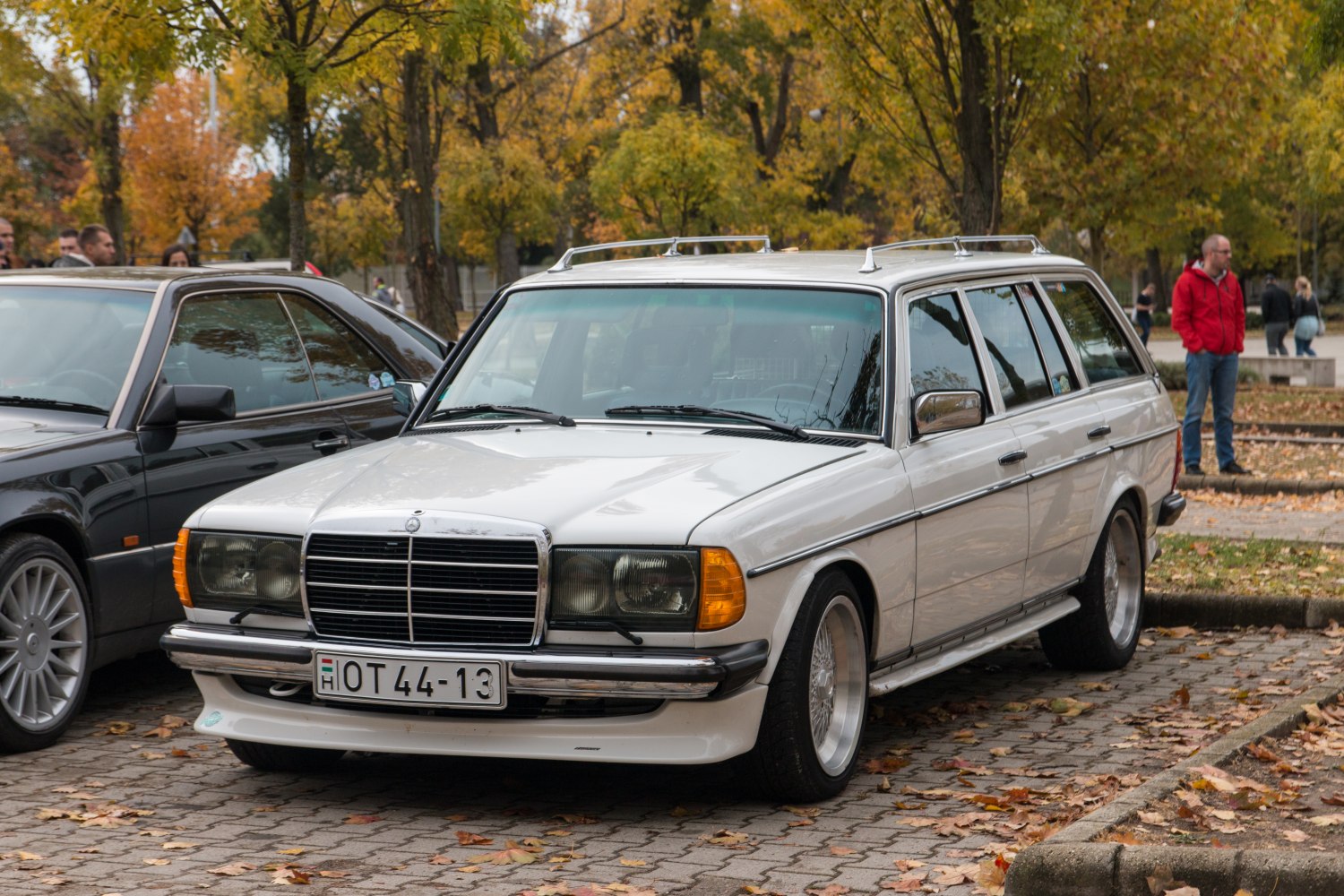 White vintage station wagon with roof rails and classic front grille