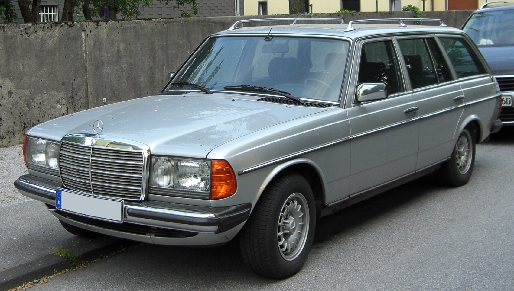 Front view of classic station wagon with chrome grille and roof rack