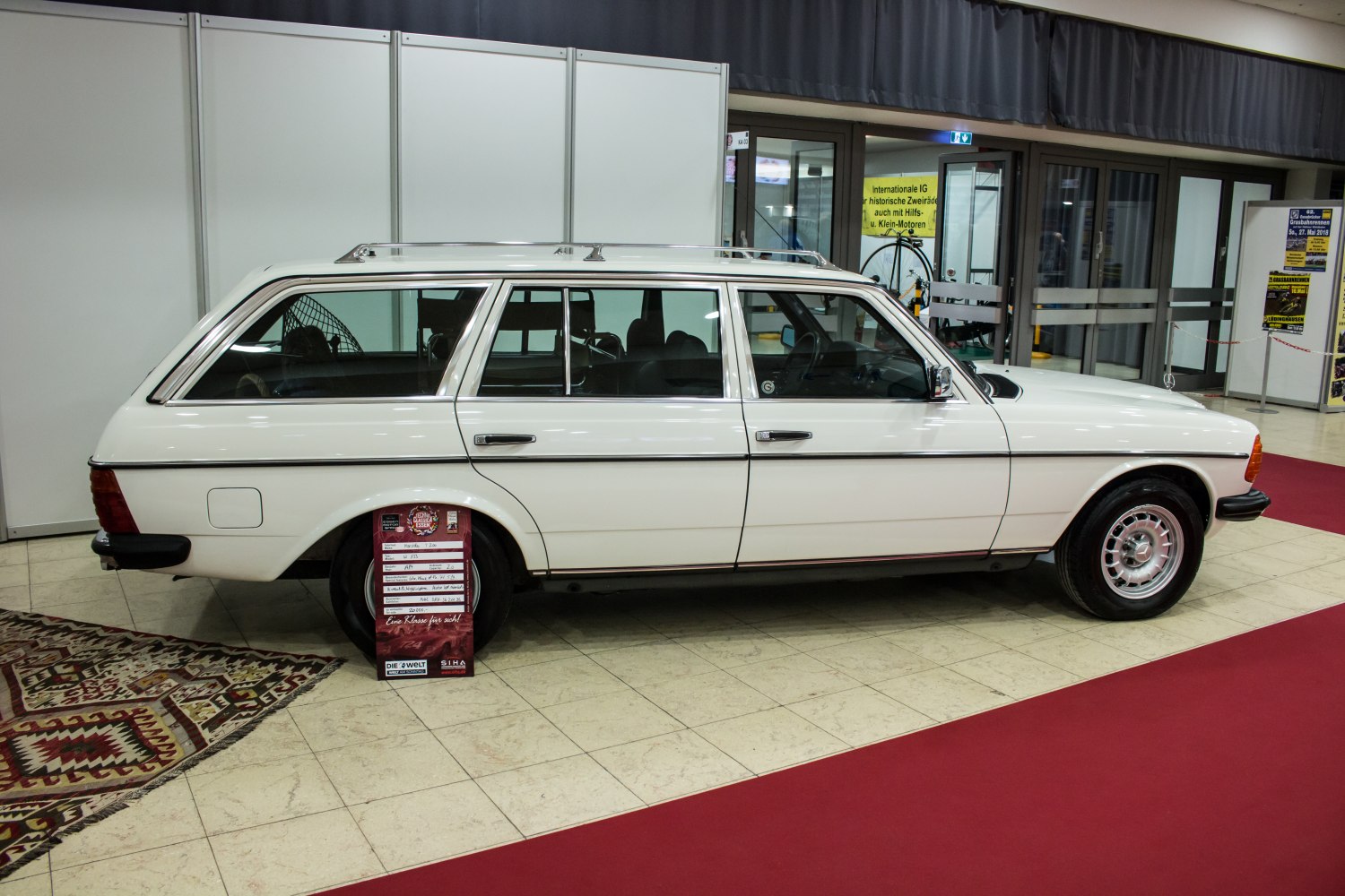 White vintage station wagon with roof rails and classic wheels side view