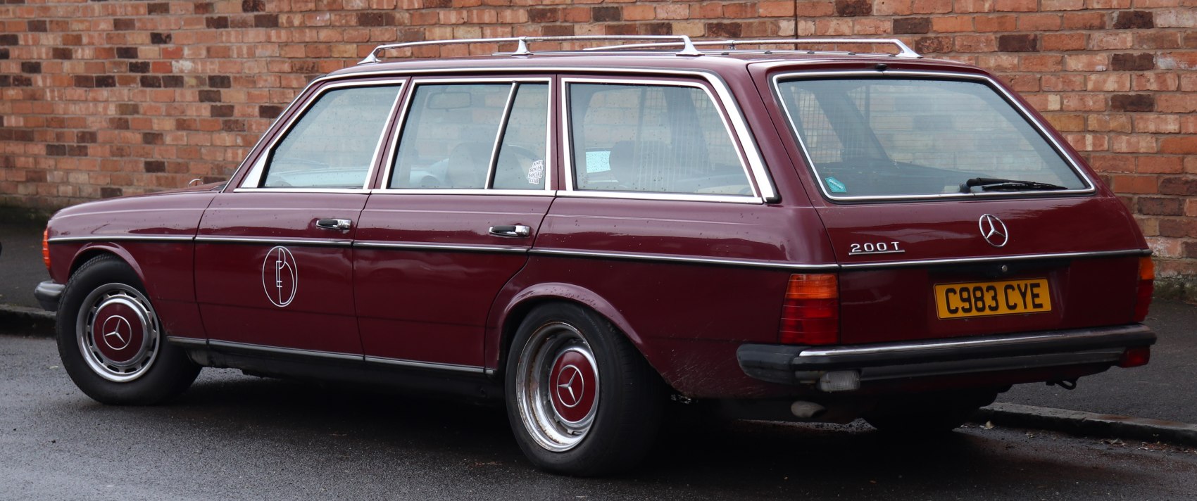Rear and side view of classic station wagon with roof rack and steel wheels.
