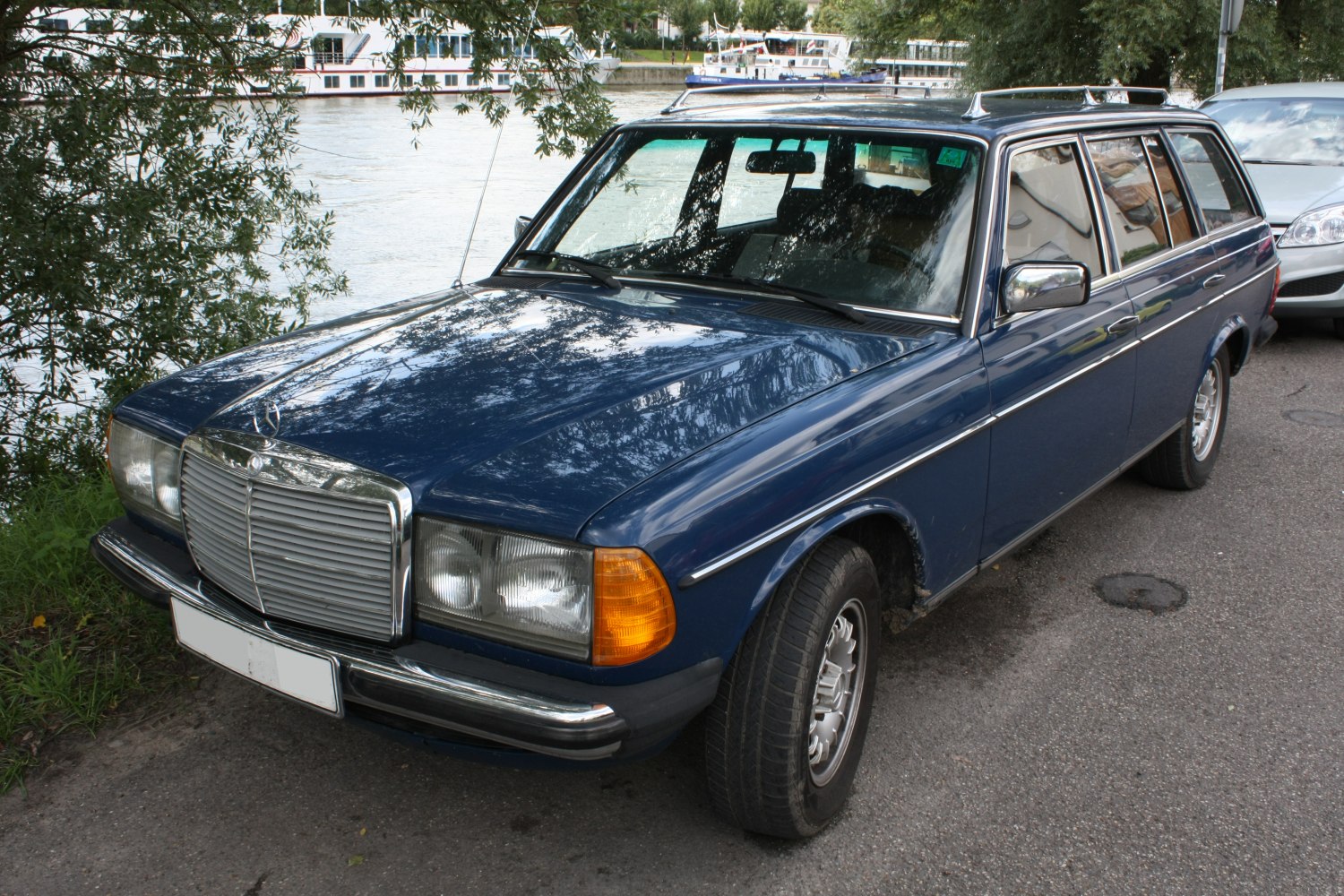 Blue vintage station wagon front side with chrome grille and rectangular headlights