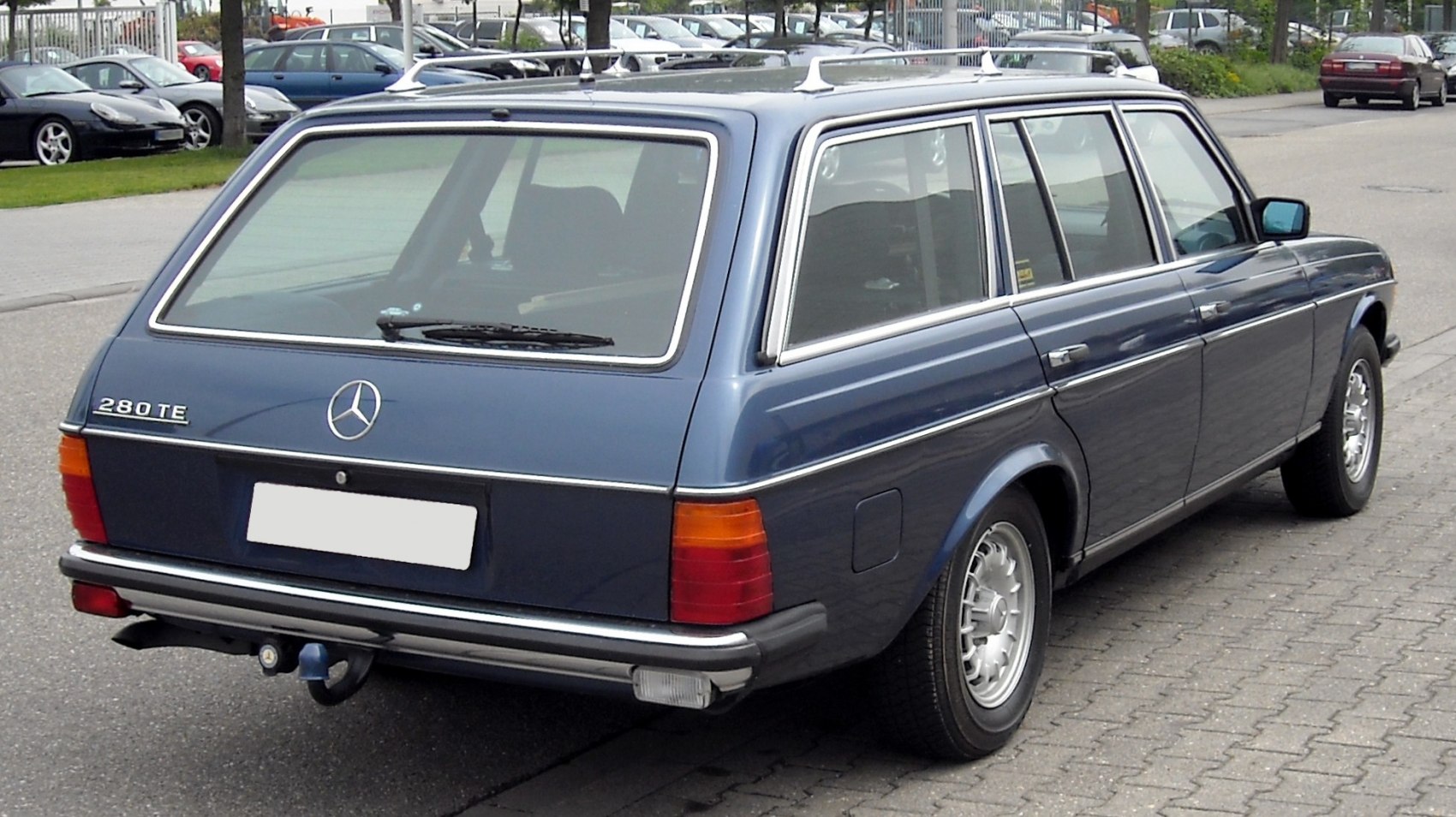 Rear and side view of a classic station wagon with roof rack.