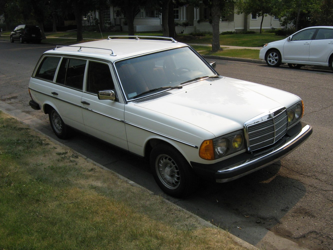 Vintage white estate car with roof rails and classic design features
