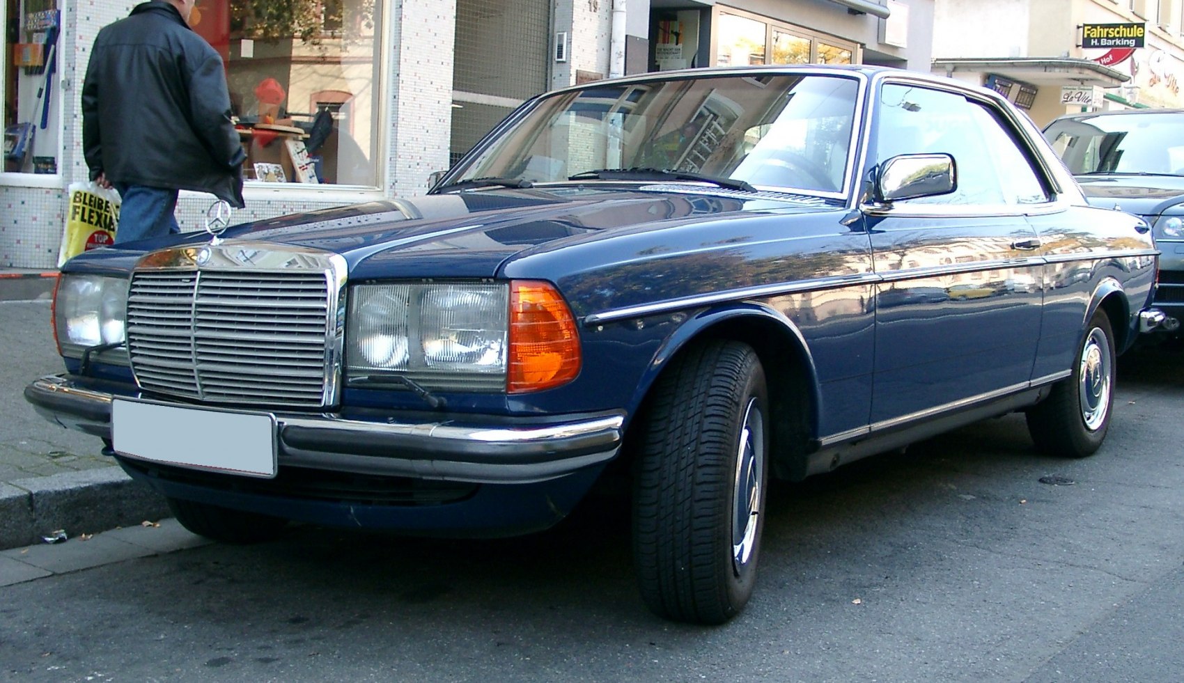 Classic vintage blue coupe with iconic chrome grille and dual rectangular headlights