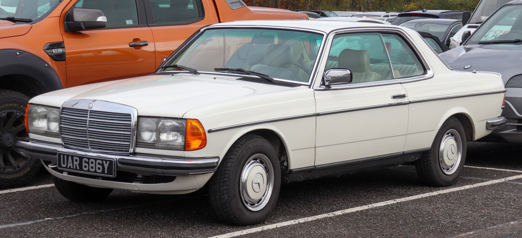 1977 two-door coupe with chrome grille and vintage round headlights