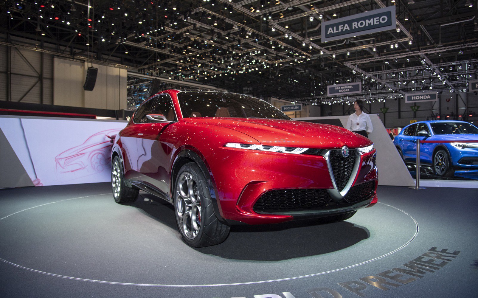 Front view of sporty SUV with sleek headlights and distinctive grille