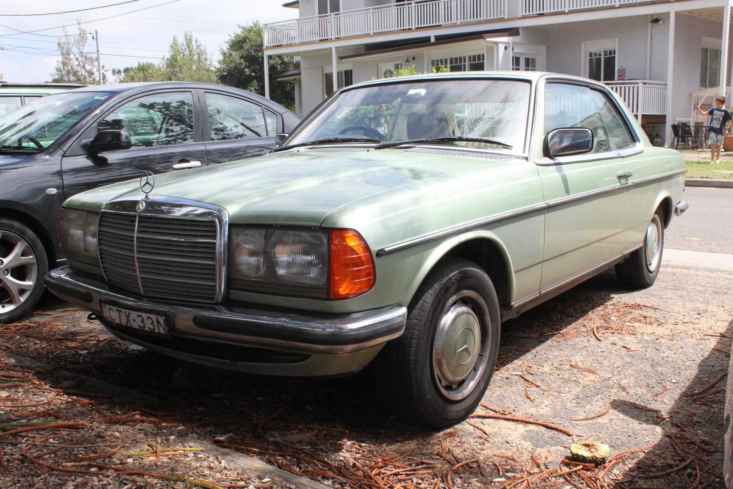Two-door vintage coupe with large grille and angular headlights