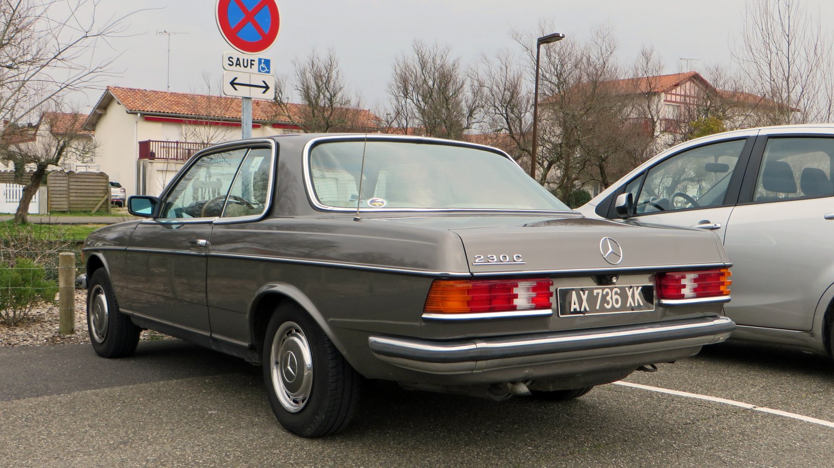 Rear view of a vintage coupe with classic taillights and smooth body lines