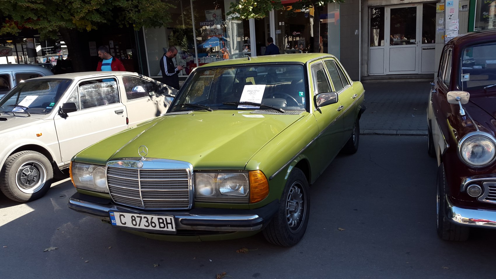 Front view of vintage sedan with chrome grille and dual headlights