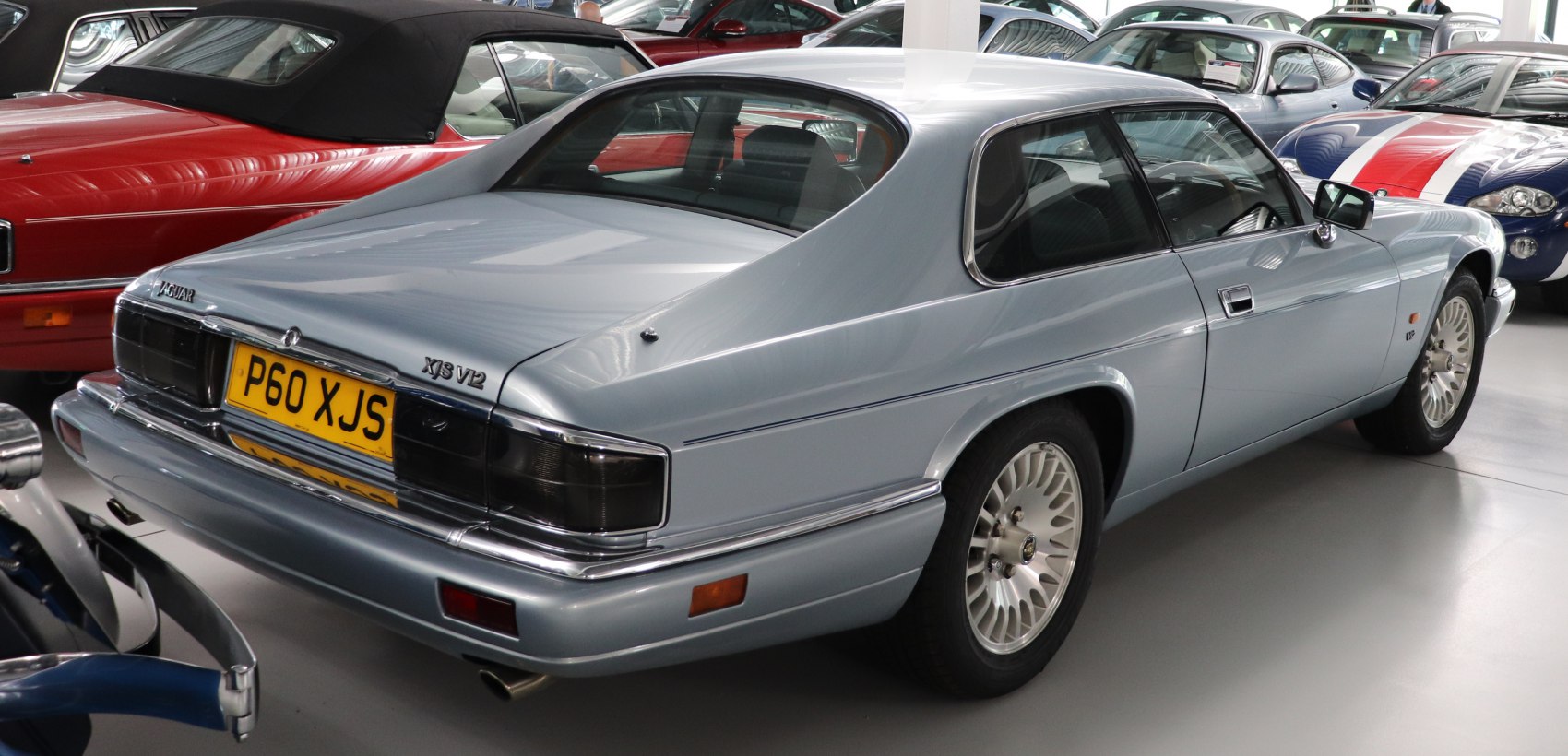 Rear view of a coupe with smoked tail lights and multi-spoke alloy wheels