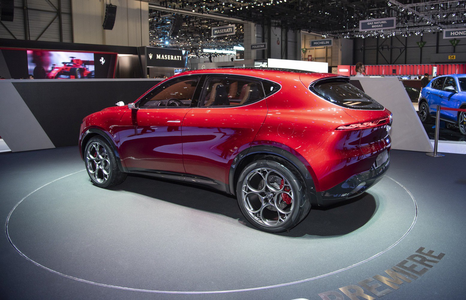 Glossy red sporty SUV rear side with circular alloy wheels